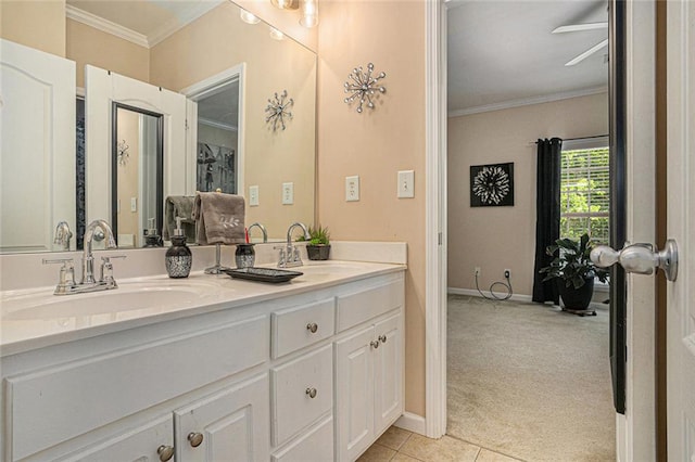 full bathroom featuring double vanity, crown molding, baseboards, and a sink