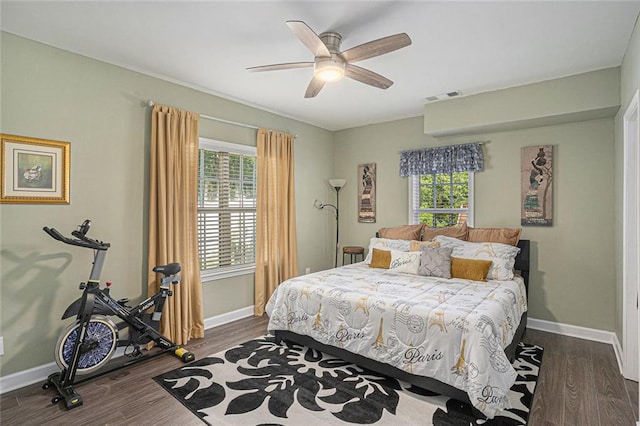bedroom featuring multiple windows, visible vents, and baseboards