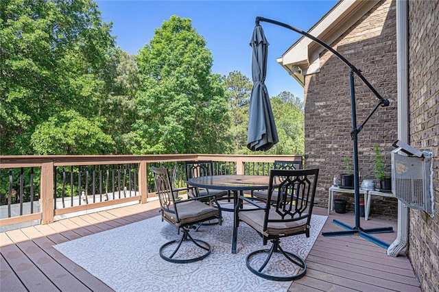 wooden terrace featuring outdoor dining space