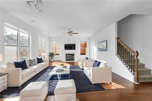 living room with ceiling fan and dark hardwood / wood-style floors