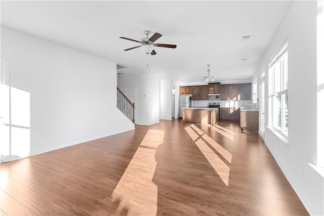 living room featuring ceiling fan, dark hardwood / wood-style flooring, and sink