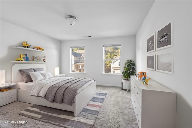 bedroom featuring light colored carpet