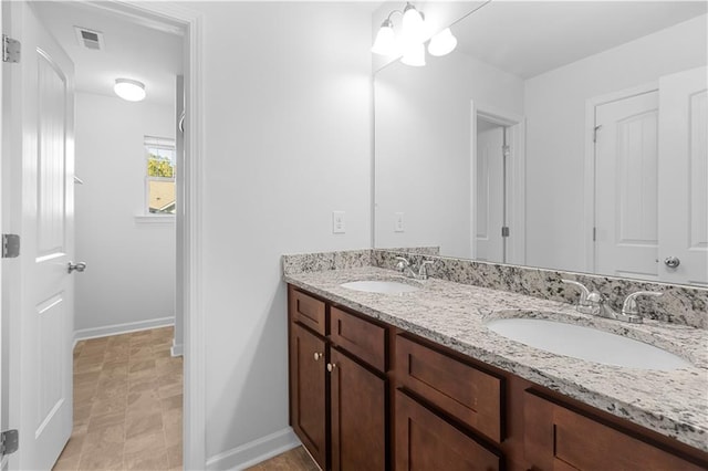 bathroom with vanity and a chandelier