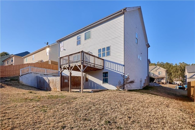 back of house with a lawn and a wooden deck