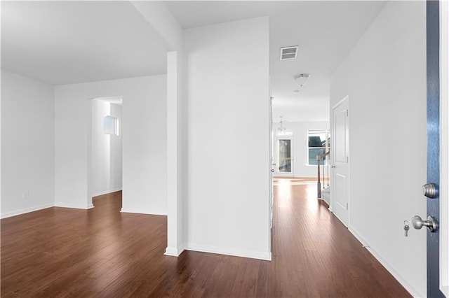 corridor featuring dark hardwood / wood-style flooring