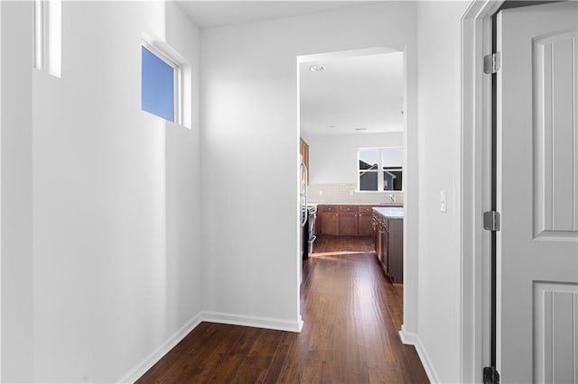 corridor with dark wood-type flooring