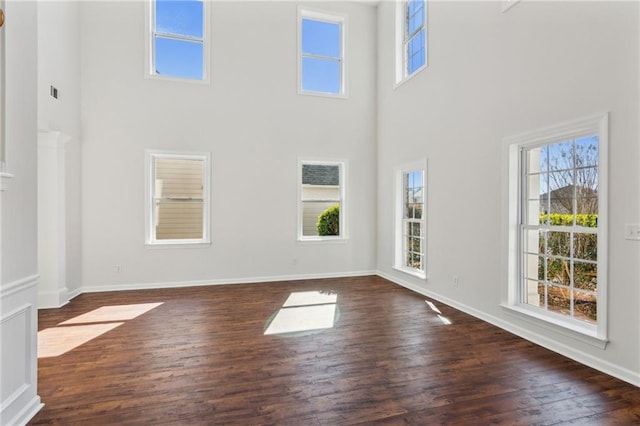 interior space featuring dark hardwood / wood-style floors and a towering ceiling