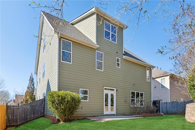 back of property featuring a patio area and a lawn