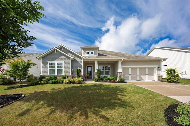 craftsman-style house featuring concrete driveway, a garage, and a front yard