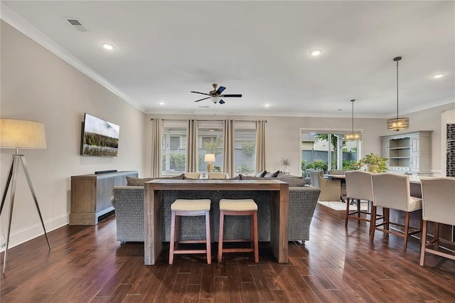 dining room featuring ceiling fan, dark wood-style floors, recessed lighting, crown molding, and baseboards