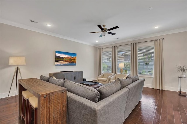 living area with ceiling fan, baseboards, dark wood finished floors, recessed lighting, and ornamental molding