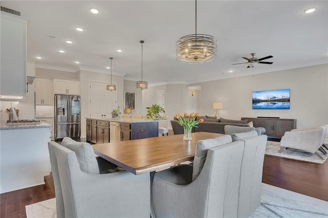 dining area featuring dark wood-style flooring, ceiling fan, crown molding, and recessed lighting