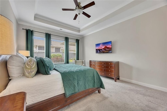 bedroom with carpet floors, a raised ceiling, ceiling fan, and baseboards