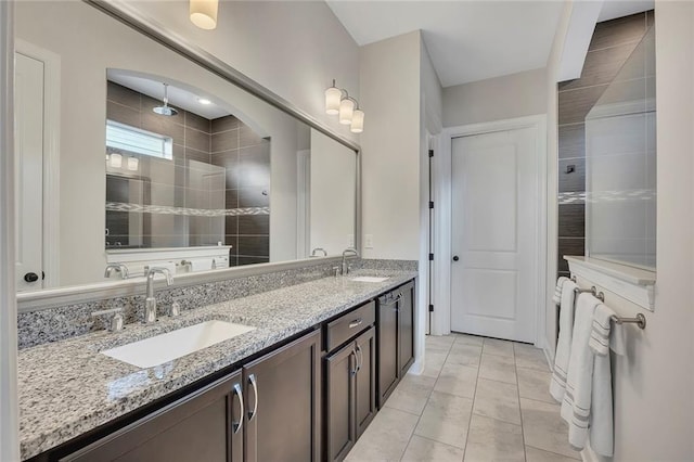 full bathroom featuring a tile shower and double vanity