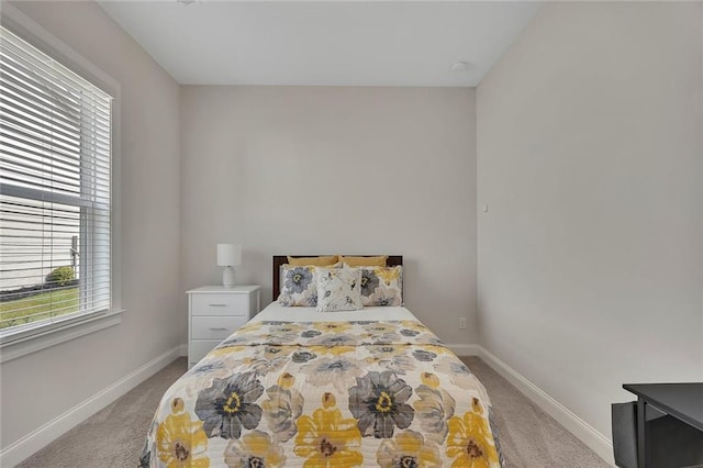 carpeted bedroom featuring baseboards