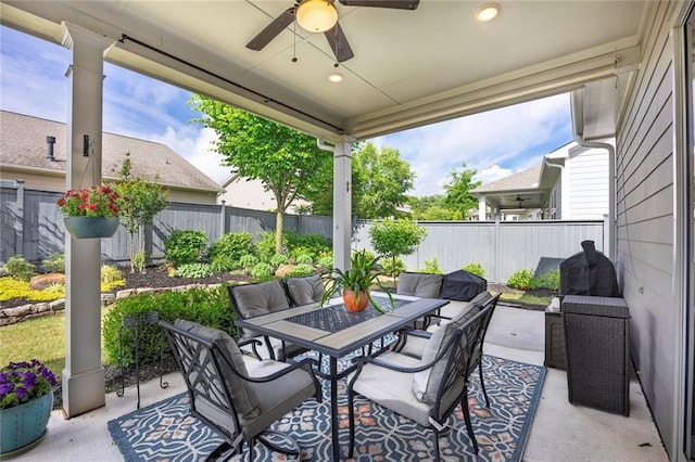 view of patio / terrace featuring outdoor dining area, a ceiling fan, and a fenced backyard