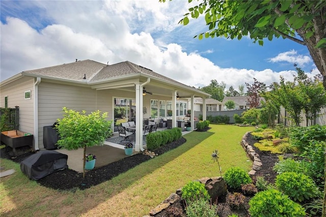back of house featuring a ceiling fan, outdoor lounge area, and a patio area