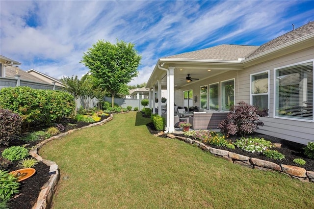 view of yard with ceiling fan and a patio