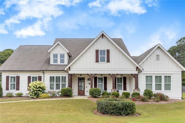 view of front of home featuring board and batten siding, covered porch, and a front lawn