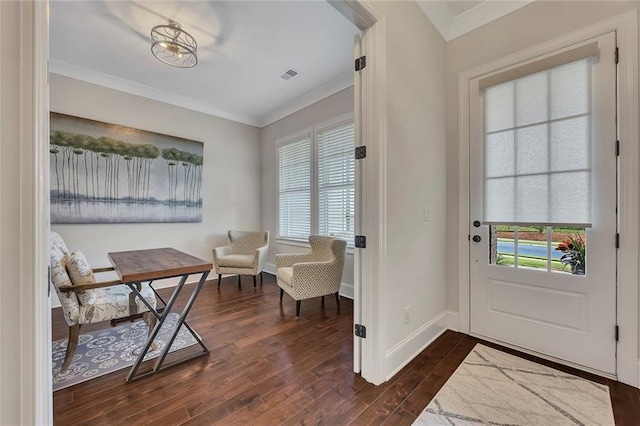 doorway to outside with dark wood-style flooring, ornamental molding, and baseboards