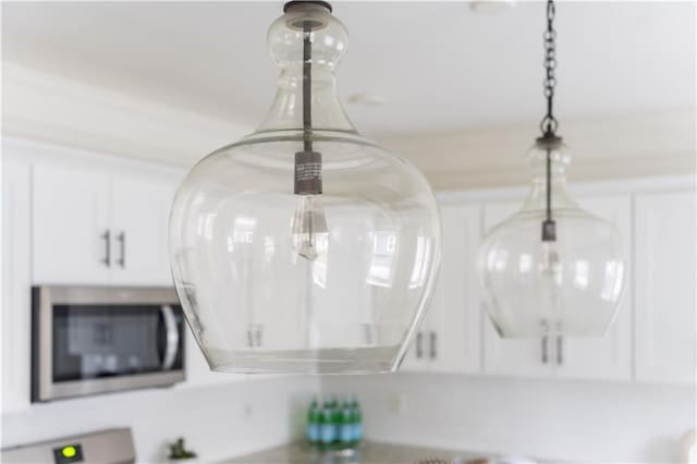 room details with stainless steel microwave and white cabinets