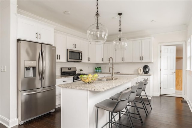 kitchen featuring ornamental molding, dark wood-style flooring, appliances with stainless steel finishes, and a sink