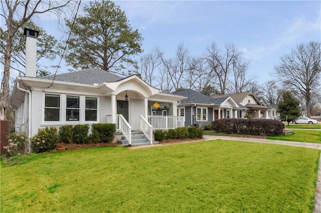 view of front of house featuring a chimney and a front lawn