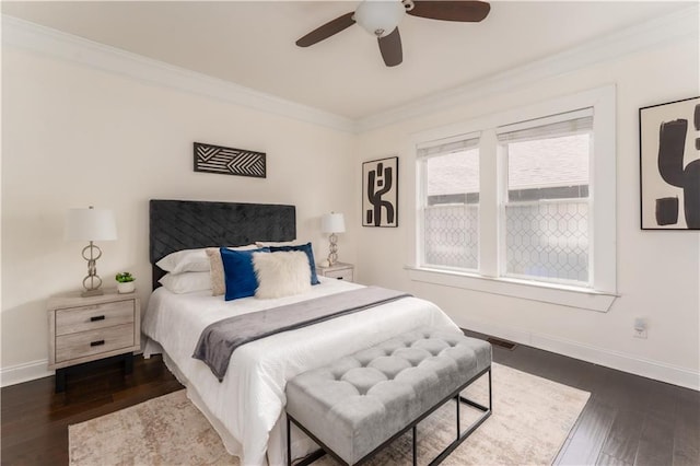 bedroom with crown molding, baseboards, and dark wood-style flooring