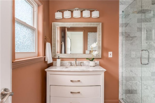 bathroom with a stall shower and vanity