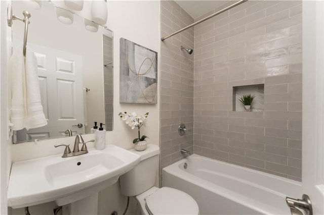 bathroom featuring a sink, toilet, and shower / washtub combination