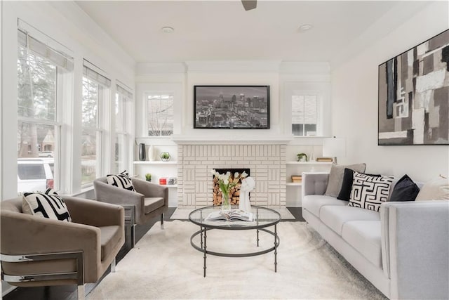 living room featuring a fireplace and crown molding