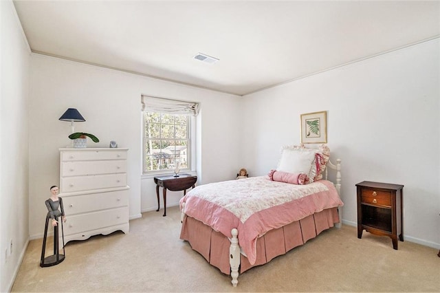 bedroom featuring baseboards, visible vents, and light colored carpet