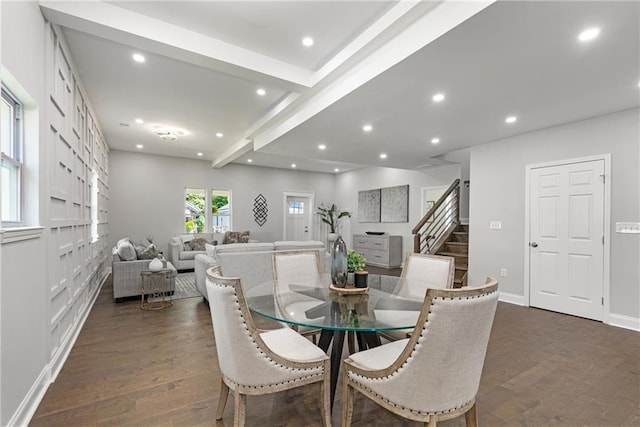 dining room with beam ceiling and dark wood-type flooring