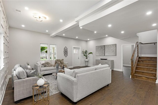 living room featuring beam ceiling and dark hardwood / wood-style floors