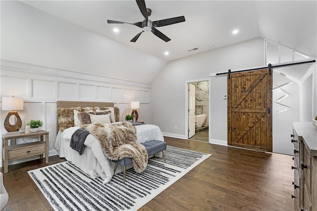 bedroom featuring ensuite bathroom, ceiling fan, a barn door, and dark hardwood / wood-style floors