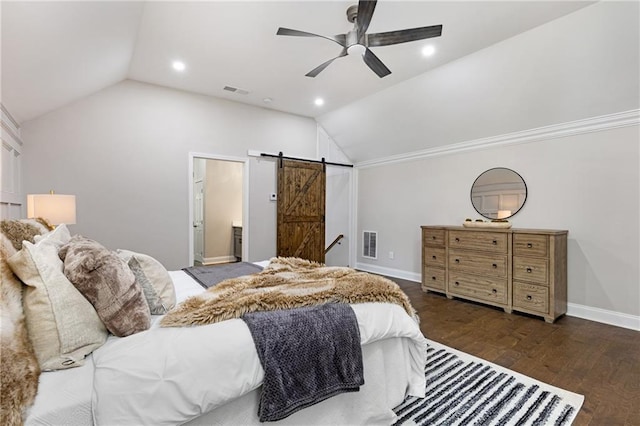 bedroom featuring vaulted ceiling, connected bathroom, ceiling fan, a barn door, and dark hardwood / wood-style flooring