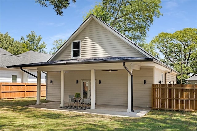 back of property with a patio area and a yard