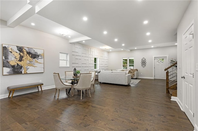 dining area featuring dark wood-type flooring and beamed ceiling