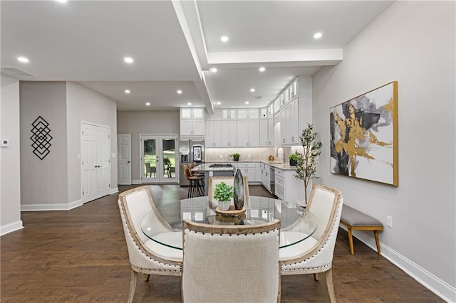 dining room featuring sink and dark wood-type flooring