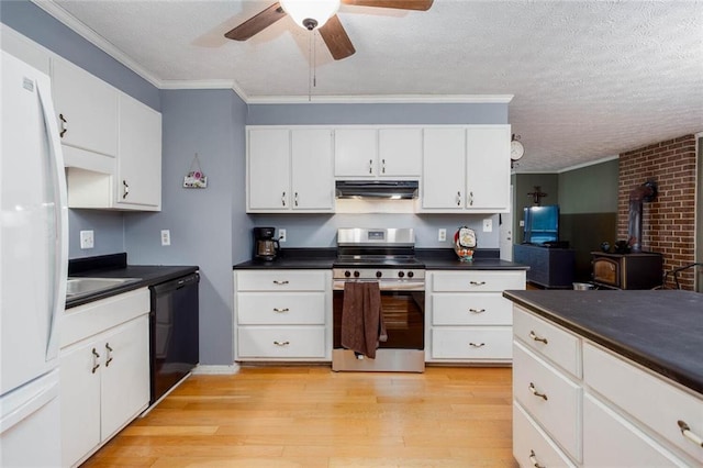 kitchen featuring stainless steel electric range, under cabinet range hood, black dishwasher, a wood stove, and dark countertops