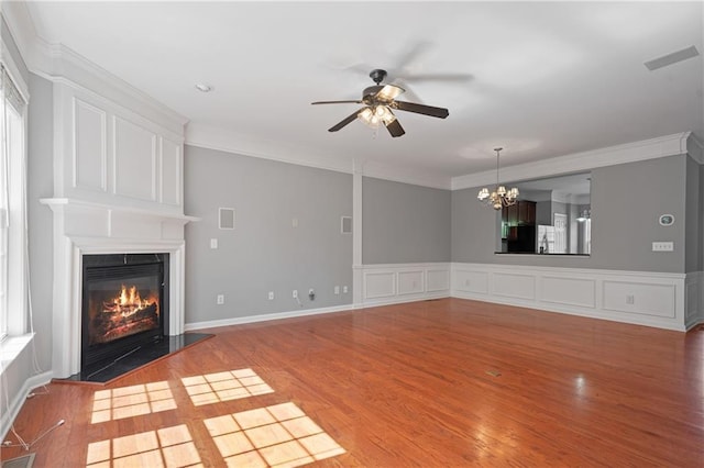 1530 Wehunt Cir SE Unit 19, Smyrna, GA 30082 - unfurnished living room featuring wood finished floors, visible vents, ornamental molding, a glass covered fireplace, and ceiling fan with notable chandelier