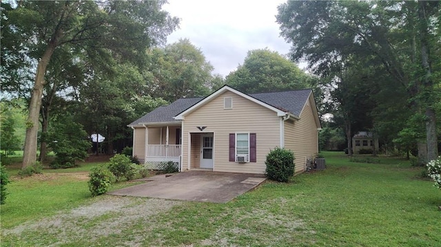 1581 Jersey Social Circle Rd, Covington, GA 30014 - view of front of property with a front yard, a porch, driveway, central air condition unit, and view of wooded area