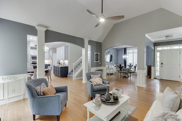 1045 Legacy Walk, Woodstock, GA 30189 - living room with arched walkways, high vaulted ceiling, a ceiling fan, a wainscoted wall, and a decorative wall