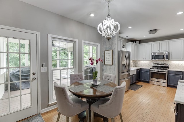 1045 Legacy Walk, Woodstock, GA 30189 - dining space featuring a chandelier, light wood-style floors, healthy amount of natural light, and recessed lighting