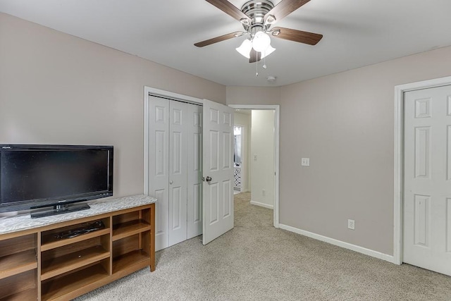 1045 Legacy Walk, Woodstock, GA 30189 - unfurnished bedroom with light colored carpet, baseboards, ceiling fan, and a closet
