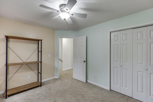1045 Legacy Walk, Woodstock, GA 30189 - unfurnished bedroom featuring carpet flooring, baseboards, a closet, and ceiling fan