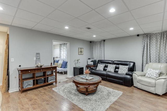 1045 Legacy Walk, Woodstock, GA 30189 - living room featuring light wood-style floors, recessed lighting, a paneled ceiling, and baseboards