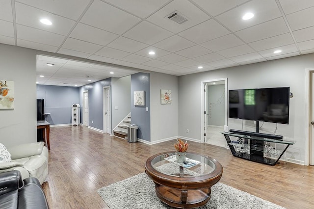 1045 Legacy Walk, Woodstock, GA 30189 - living area featuring wood finished floors, stairway, recessed lighting, baseboards, and a paneled ceiling