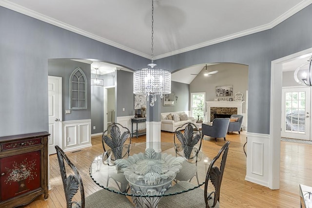 1045 Legacy Walk, Woodstock, GA 30189 - dining area with arched walkways, a chandelier, light wood-style floors, plenty of natural light, and crown molding