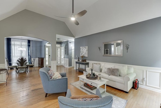 1045 Legacy Walk, Woodstock, GA 30189 - living room featuring arched walkways, a decorative wall, wainscoting, ceiling fan, and light wood finished floors